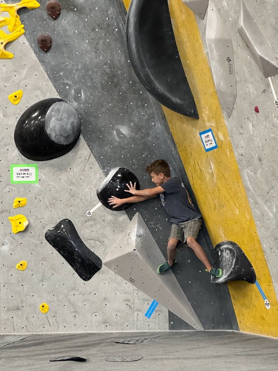 Youth climber competing in a USA Climbing Bouldering competition